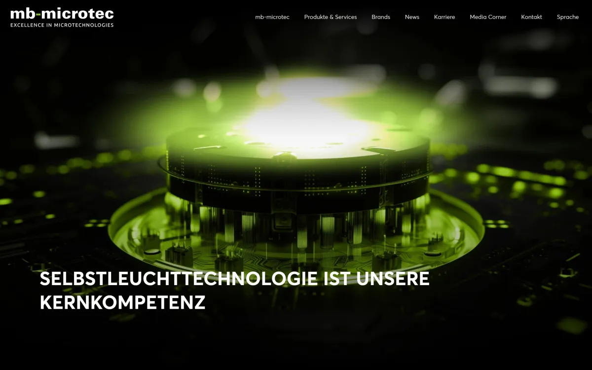 Startseite von mbmicrotec.com auf dem Desktop: grün leuchtendes Bauteil und Leitsatz zur Selbstleuchttechnologie